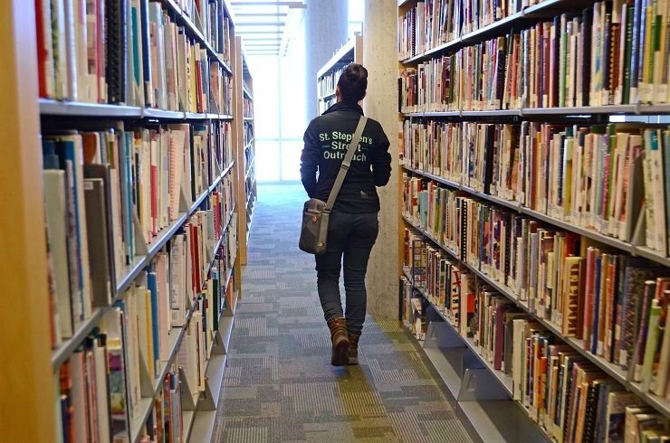 Kate walking library aisle.jpg